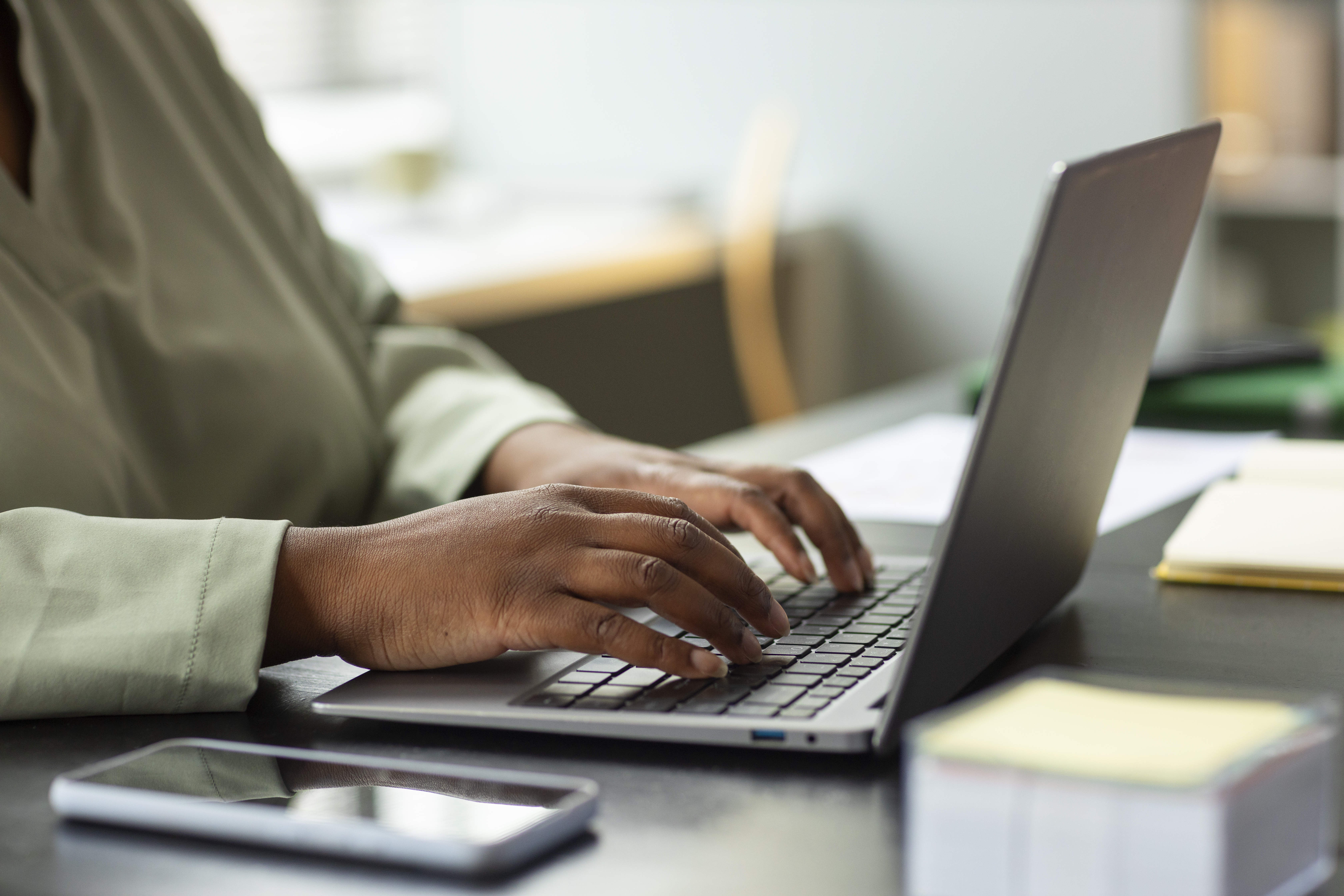 Care coordinator working at a laptop