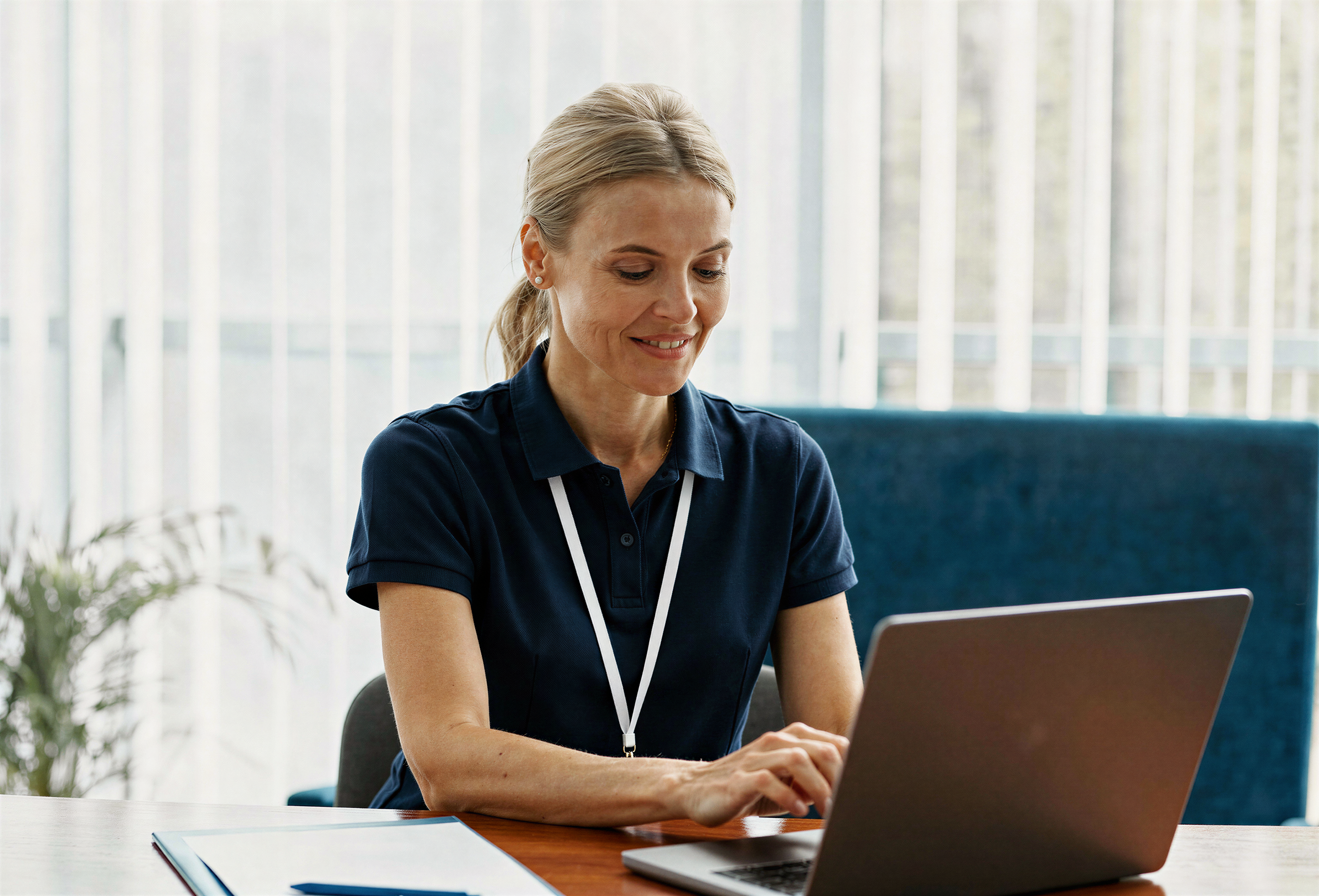 Payroll professional working on a laptop